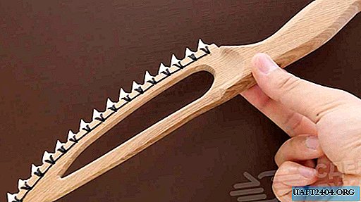 Cuchillo afilado hecho de madera y dientes de tiburón