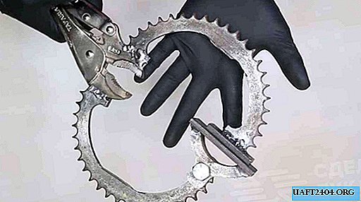 Hand clamp made of metal pliers and sprockets from a motorcycle