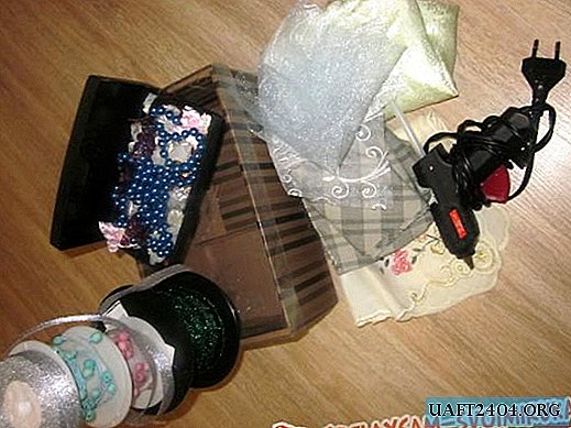 Kovček, okrašen s tkanino, tkaninami in rožicami