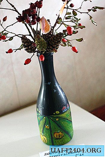 Vase from a bottle with autumn ikebana