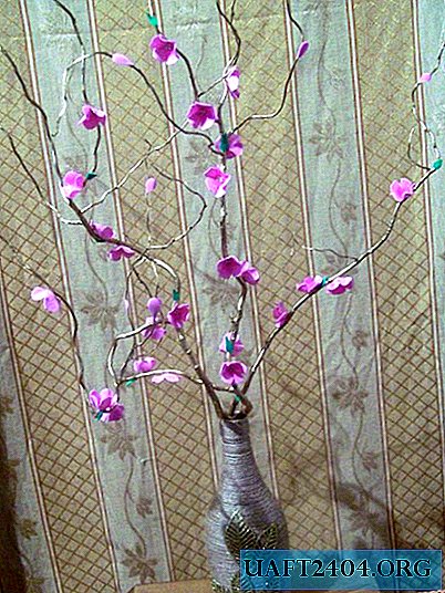 Vase with flowers on a branch
